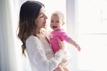 newborn baby in the hand of his mother at the window