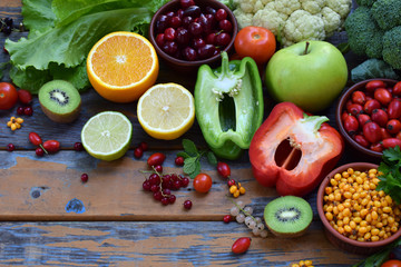 Composition of products containing ascorbic acid, vitamin C - citrus, cauliflower, broccoli, sweet pepper, kiwi, dog rose, tomatoes, apple, currant, sea buckthorn, dogwood. Top view. Flat lay.