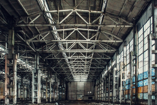 Large empty abandoned warehouse building or factory workshop