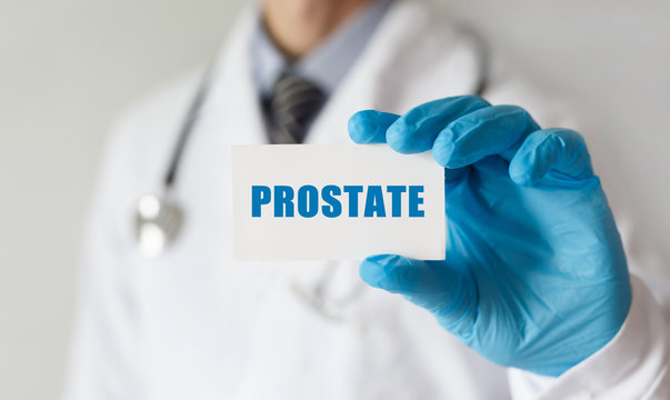 Doctor holding a card with text PROSTATE, medical concept