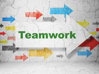 Business concept:  arrow with Teamwork on grunge textured concrete wall background, 3D rendering