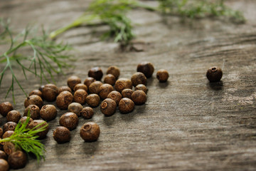 pepper peas and green dill on a wooden background.