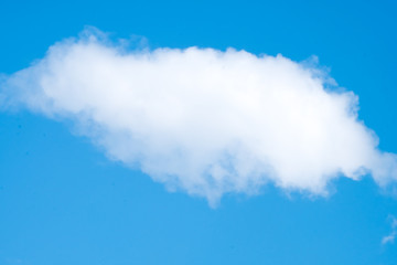 White single cloud in the blue sky.