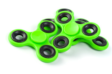 Green fidget spinners - stress relieving toys on a white background