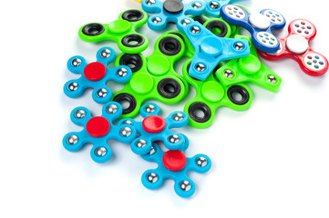 Various colored fidget spinners - stress relieving toys on a white background