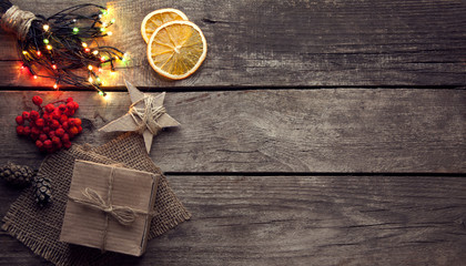 Christmas gift box and decorations on wooden background copy space for lettering top view