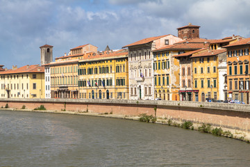 Bright italian houses on the Arno river in Pisa, Tuscany, Italy.