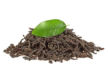 Dry black tea with leaf isolated on a white background