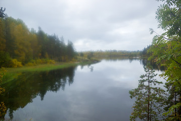 Fototapeta na wymiar Yellow Fall at Lake through Misted Glass Autumn Water Reflection Landscape