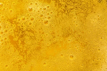 Foto op Canvas Close up of beer bubbles and foam as a background © Nikolay N. Antonov