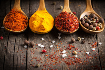 Spices. Spice in Wooden spoon. Herbs. Curry, Saffron, turmeric, cinnamon and other on a wooden...