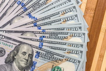 american dollar on wooden desk. close up