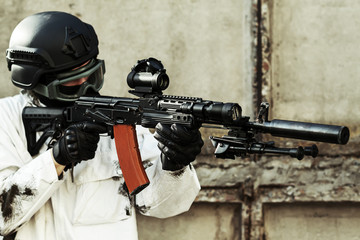 man aiming with an AK-47