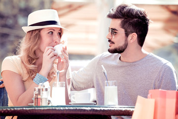 Happy couple drinking coffee in cafe.