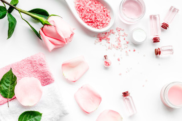 Natural organic cosmetics with rose oil. Cream, lotion, spa salt on white background top view
