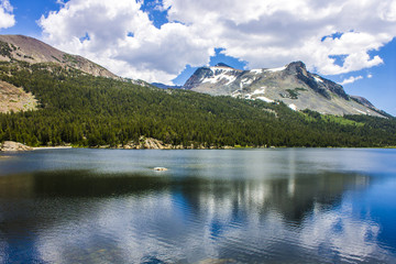 Views of Tenaya Lake, an alpine lake in Yosemite National Park, California, located at an elevation...