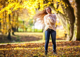 Enjoy autumn happy woman on colorful fall background