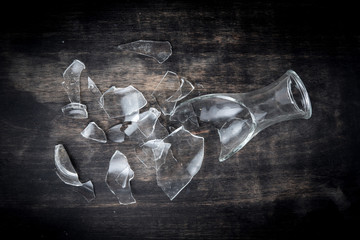 Broken bottle glass on wooden floor