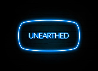 Unearthed  - colorful Neon Sign on brickwall