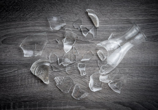 Broken bottle glass on wooden floor