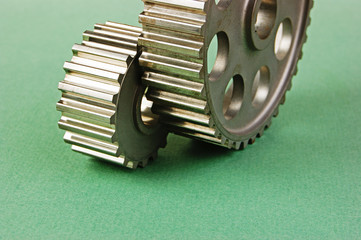 Two gears on a green background