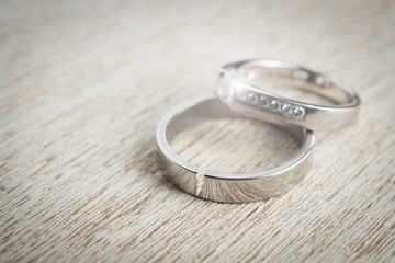 Cracked silver wedding ring on wood,Divorce and ending relationship concept
