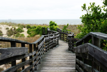 Fototapeta na wymiar Wooden boardwalk leading to the Beach