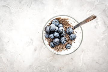 How to eat chia seeds. Dessert with yogurt, chia and blueberries on grey background top view copyspace