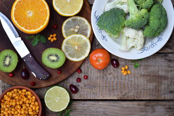 Composition of products containing ascorbic acid, vitamin C - citrus, cauliflower, broccoli, sweet pepper, kiwi, tomatoes, sea buckthorn. Top view. Flat lay.