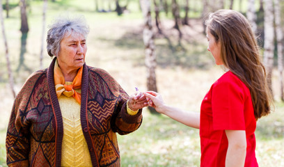 Elderly couple and young caregiver