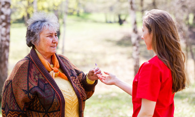 Elderly couple and young caregiver