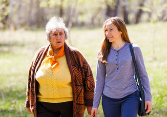 Elderly couple and young caregiver