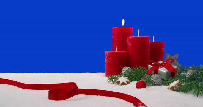 First Sunday of Advent - Christmas decoration arrangement on a snowy table in front of a blue screen - ProRes
