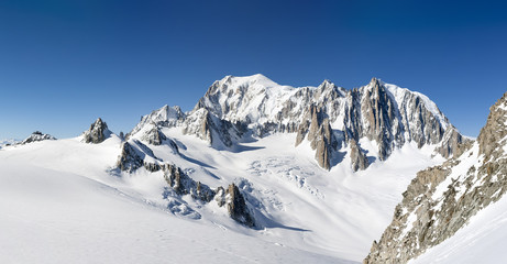 Mont Blanc, east face. Extra-large panorama of Mont Blanc Massif peaks and glaciers in a sunny winter day.