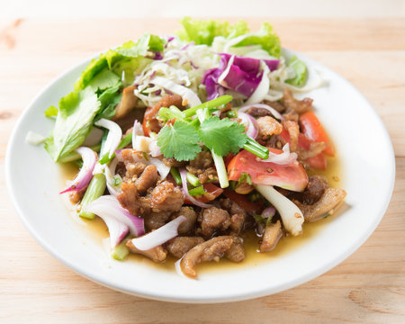 Spicy stir fried pork stips with pepper chilli on wood,thai food