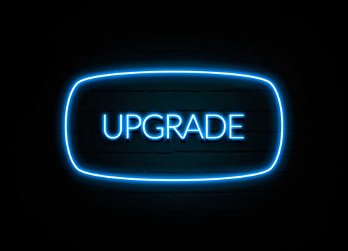 Upgrade  - colorful Neon Sign on brickwall
