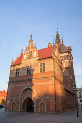 View of the Torture Chamber (Torture House) (Katownia in Polish) and Prison Tower at the Main Town (Old Town) in Gdansk, Poland, in the early evening. - obrazy, fototapety, plakaty