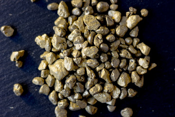 Top view of golden sand at black board.