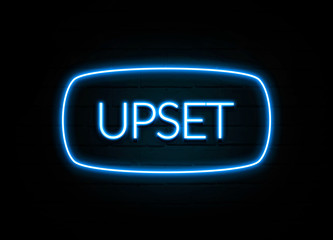 Upset  - colorful Neon Sign on brickwall