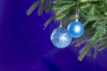 Fir branches and Christmas decorations on a dark blue background. Christmas background. Selective focus. Place for text.
