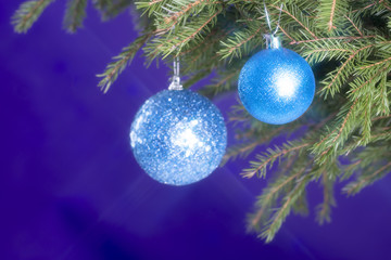 Fir branches and Christmas decorations on a dark blue background. Christmas background. Selective focus. Place for text.