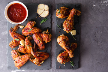 Roasted barbecue chicken wings and legs with bbq sauce, olive oil and pepper.
