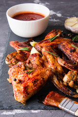 Roasted barbecue chicken wings and legs with bbq sauce, olive oil and pepper.