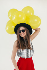 Young pretty woman with yellow balloons

