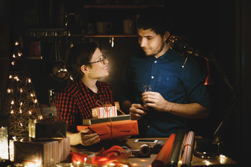 Preparation for the New Year and Christmas. man and woman pack gifts for the new year.