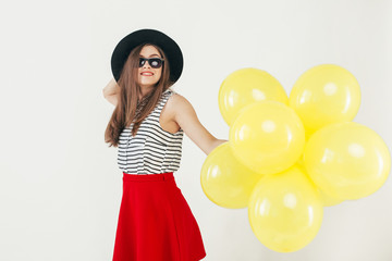 Young pretty woman with yellow balloons

