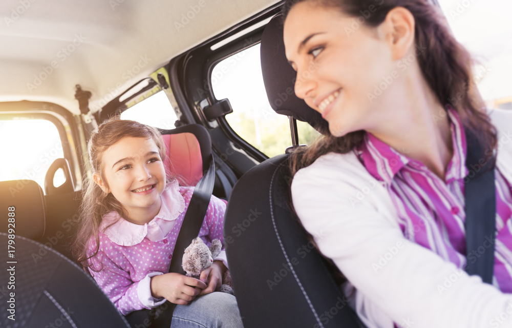 Wall mural girl in the car with her mother