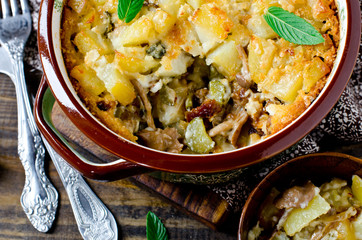 Potato casserole with meat, mushrooms and pickled cucumbers