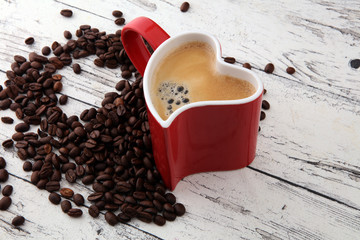 Red Heart Coffee cup and beans on table