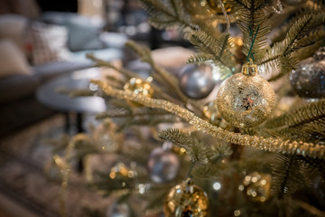 Christmas tree in living room with golden colored decorations
